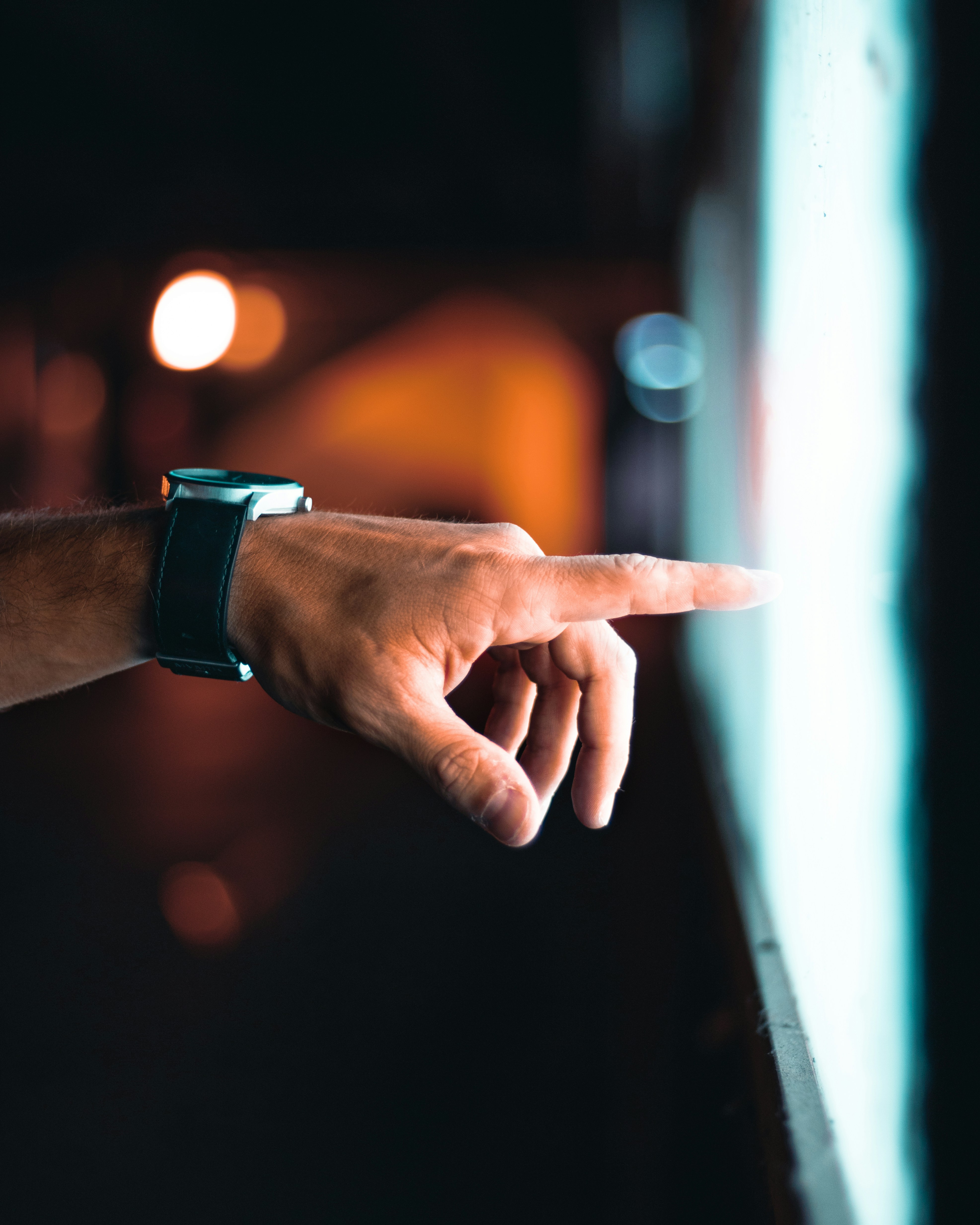 A finger meeting a glowing screen